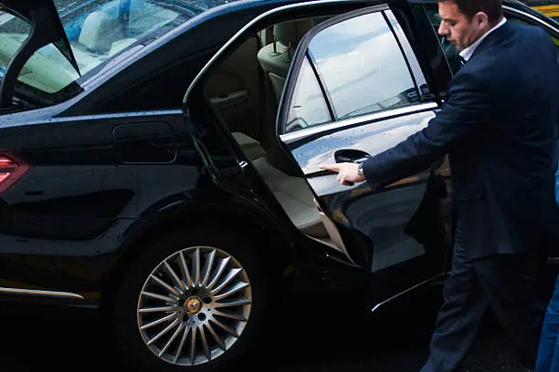London. UK - May 20, 2015: Ðriver with assistant met the businessman at the airport in London.  luxury Mercedes sedan. rainy day
